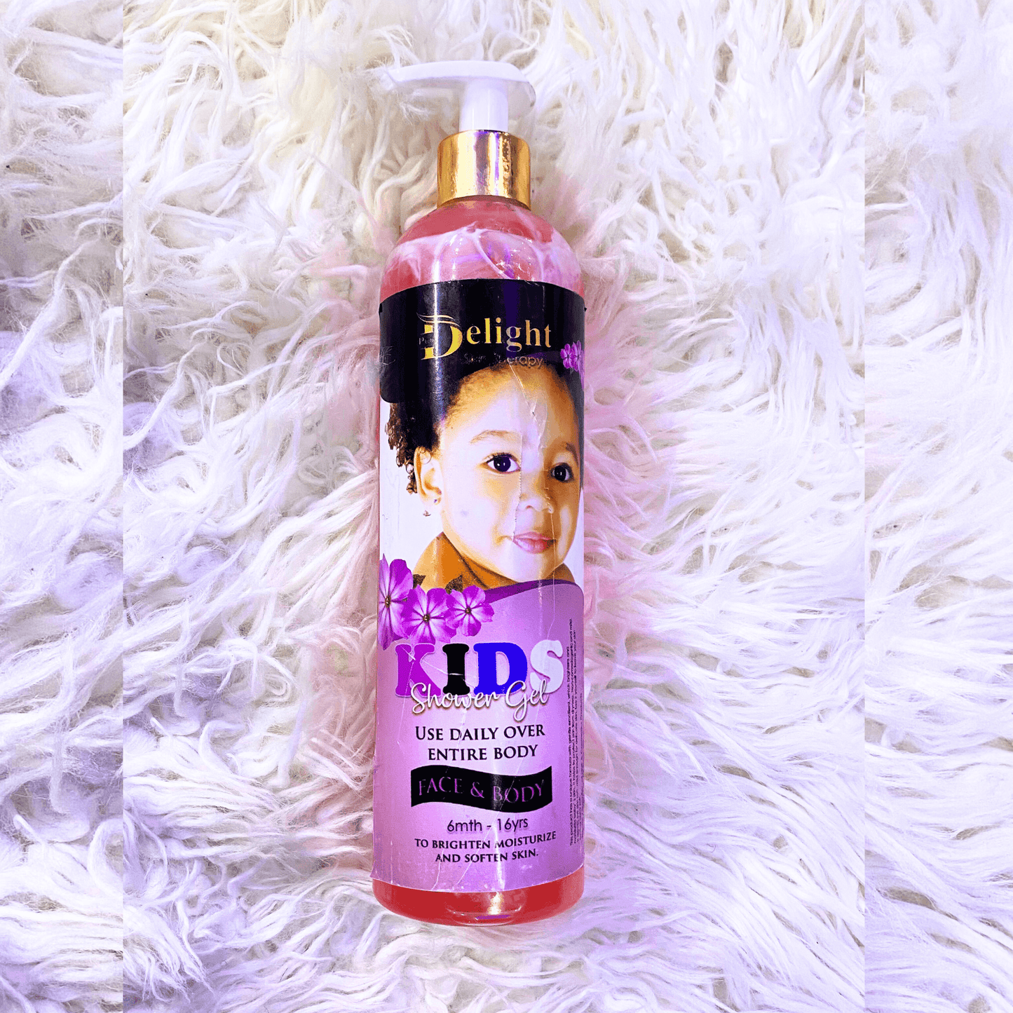 Bottle of 'Delight' Kids shower gel on a white textured background