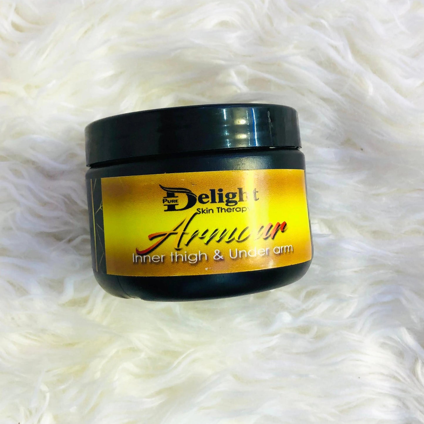 MazzyCosmetics-spa Armour cream for inner thigh & underarm in a black jar on a fluffy surface
